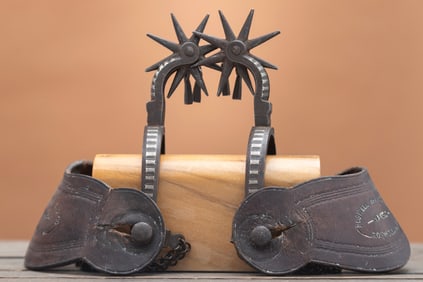 Pair of double mounted silver inlaid iron Spurs, complete with chap guards and jingle bobs, drop