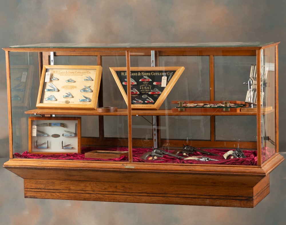 Beautiful antique oak floor model Showcase, manufactured by Kansas City Showcase Co, Kansas City,: Beautiful antique oak floor model Showcase, manufactured by Kansas City Showcase Co, Kansas City, Mo., double sliding glass rear doors, beveled glass top and adjustable shelves, measures 42" T x 25 1/