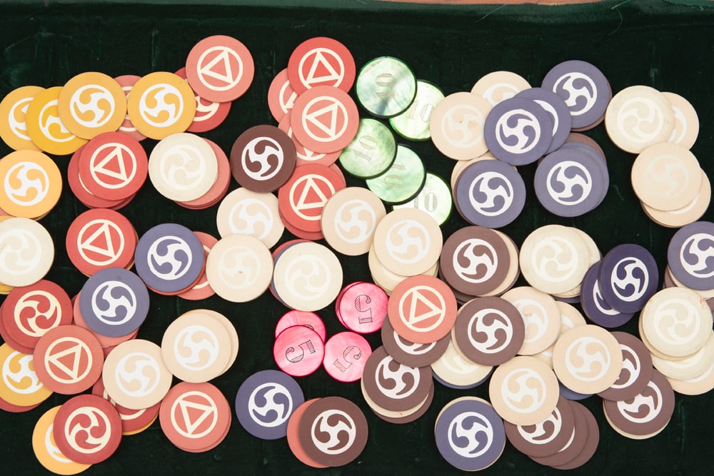 Wooden and glass Boxed collection of Poker Chips. 10 Mother of Pearl Chips with 5 dollar and 10: Wooden and glass Boxed collection of Poker Chips. 10 Mother of Pearl Chips with 5 dollar and 10 dollar denominations. Approximately 100 Poker Chips in total. HUTCHESON COLLECTION.