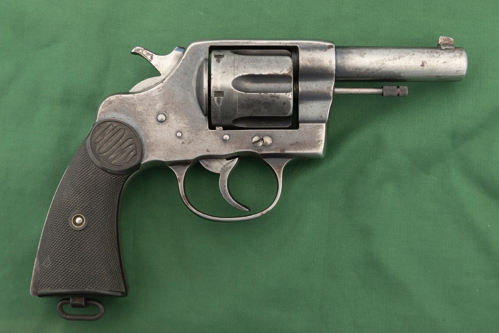 Colt New Service, DA Revolver, .38 WCF caliber, aka .38/40, SN 13370, manufactured 1905, under the: Colt New Service, DA Revolver, .38 WCF caliber, aka .38/40, SN 13370, manufactured 1905, under the left grip marked "Sheriff Romero", retains much of original blue finish in protected areas, 3 1/2" ba