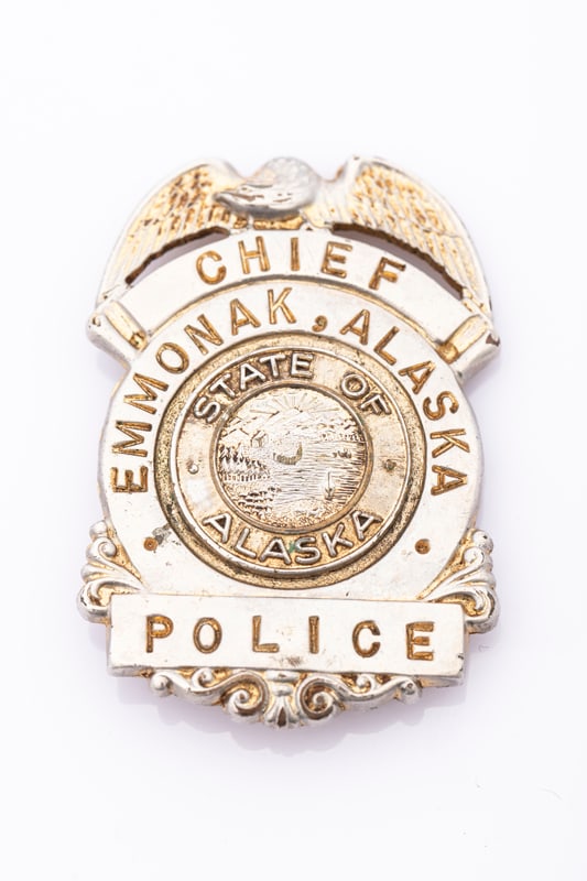 Vintage Shield Badge with eagle crest marked "Chief / Emmonak, Alaska / Police" with "State of: Vintage Shield Badge with eagle crest marked "Chief / Emmonak, Alaska / Police" with "State of Alaska" center seal. Badge is hallmarked "George F. Cake / Co. / Berkely, Cal.", pin is loose with small