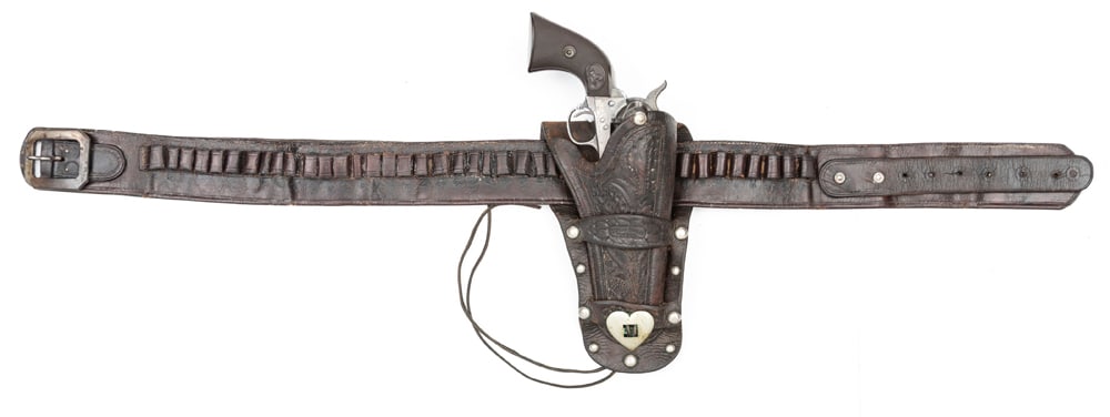 Double Loop Holster, Cartridge & Money Belt. Holster is tooled and maker marked "S.C. Gallup / Sadl.: Double Loop Holster, Cartridge & Money Belt. Holster is tooled and maker marked "S.C. Gallup / Sadl. Co.". Holster has spots around outside border with silver heart at lower center. Holster is for a 5