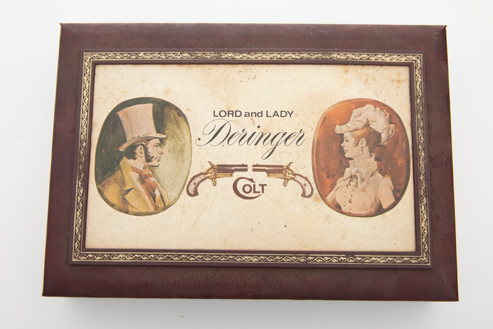 A cased pair of Colt Single Shot Derringers in consecutive SN's 4455LDR / 4456LDR, .22 Short: A cased pair of Colt Single Shot Derringers in consecutive SN's 4455LDR / 4456LDR, .22 Short caliber, one is in gold finish the other is in gold finish with blue barrel, all factory original, 2 1/2" b