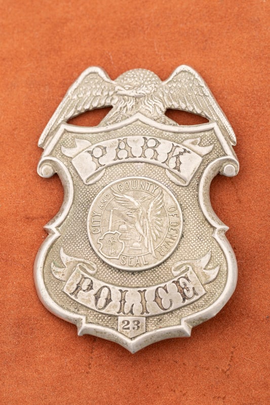 Large vintage Shield Badge with eagle crest marked "Park Police / 23" with raised "City and County: Large vintage Shield Badge with eagle crest marked "Park Police / 23" with raised "City and County of Denver Seal" in center. Badge has traces of black enamel in the circus style lettering, measures 3