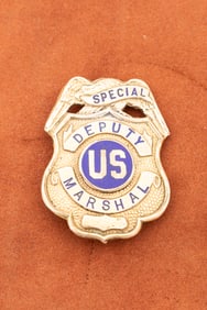 Vintage gold Shield Badge with eagle crest marked "Special Deputy Marshal" with "US" in center seal.