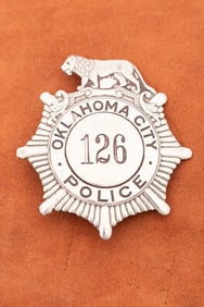 Sunburst shaped vintage Shield Badge with lion crest marked "Oklahoma City Police" with "126" in