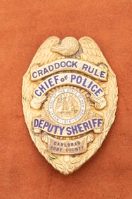 Gold colored vintage Shield Badge with winged eagle crest marked "Craddock Rule / Chief of Police /