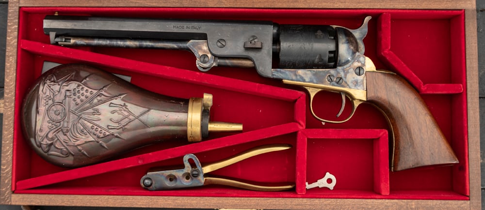 Cased replica of an 1851 Navy Revolver, barrel is marked "Black Powder, Made in Italy", .36 caliber,: Cased replica of an 1851 Navy Revolver, barrel is marked "Black Powder, Made in Italy", .36 caliber, SN C8406, pristine condition, sold with fitted wooden box, powder horn and matching bullet mold. Wi