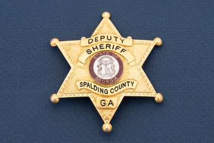 Vintage gold tone 6-point Ball Star Badge marked "Deputy Sheriff / Spalding County Ga." with "State