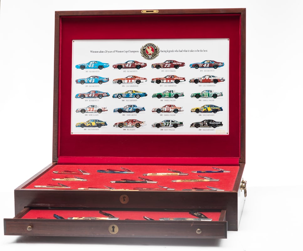 Large Mahogany lift top Case with drawer containing 21 Case Folding Knives. Twenty of these Knives: Large Mahogany lift top Case with drawer containing 21 Case Folding Knives. Twenty of these Knives are "Winston Salute Twenty Years of Winston Cup Champions Racing Legends Who Had What It Takes To Be 
