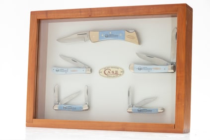 Wooden and glass counter top Showcase containing a collection of 5 Case Knives commemorating