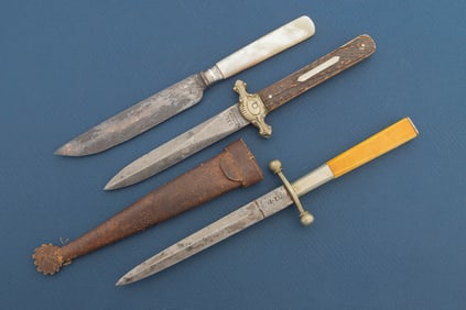 Custom glass front case with collection of three vintage Blades, including two Dirks and one mother