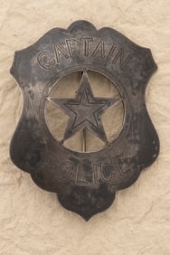 Vintage Shield Shaped Badge with 5-point cut out star center marked "Captain / Police", with hand