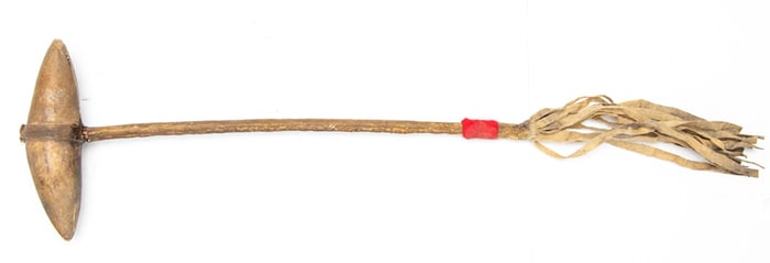 Leather wrapped War Club with double pointed head showing doe skin fringe and trades cloth. Rawhide