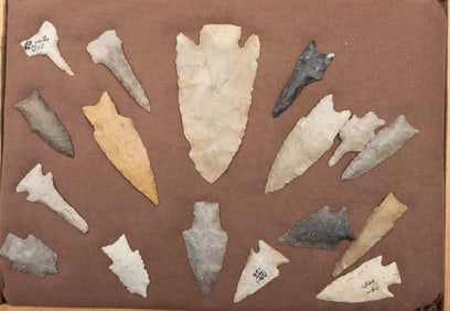 This lot consists of a collection of 17 Arrowheads and Drills in a wooden glass front Display Case