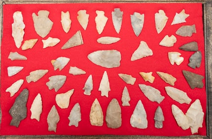 This lot consists of a collection of  47 Arrowheads and Points in a wooden and glass front Display