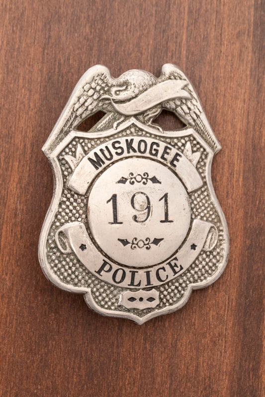 Vintage Shield Badge with eagle crest marked "Muskogee / Police" with center seal marked "191". Back: Vintage Shield Badge with eagle crest marked "Muskogee / Police" with center seal marked "191". Back is hallmarked "Liepsner / Mo.", has nice saddle pin and catch, measures 2 1/4" T x 1 3/4" W. Estima