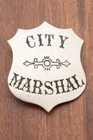 Vintage silver tone Shield Badge marked "City Marshal" in circus lettering. Hallmarked "Scotford Co.