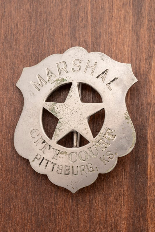 Vintage Shield Badge with cut out 5-point star center marked "Marshal / City Court / Pittsburg, Ks.": Vintage Shield Badge with cut out 5-point star center marked "Marshal / City Court / Pittsburg, Ks." Most all black enamel is missing. Hallmarked "Northwestern / Stamp Works / St. Paul, Minn.", has sm
