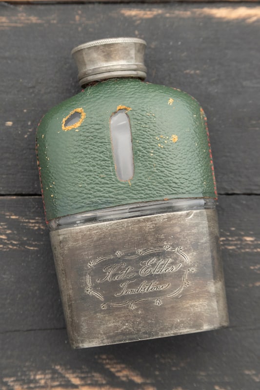 Whiskey Flask, possibly belonging to Doc Holliday's girlfriend Big Nose Kate, is 4 5/8" T x 2 1/2": Whiskey Flask, possibly belonging to Doc Holliday's girlfriend Big Nose Kate, is 4 5/8" T x 2 1/2" W. The top portion of this flask is leather wrapped with silver lid, lower portion is an unusual silv
