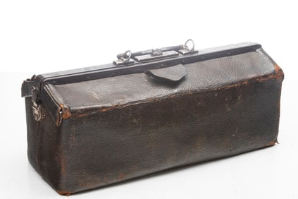 Early leather wrapped Dr.s bag with silver medallion under leather flap. Medallion is marked  "Dr.