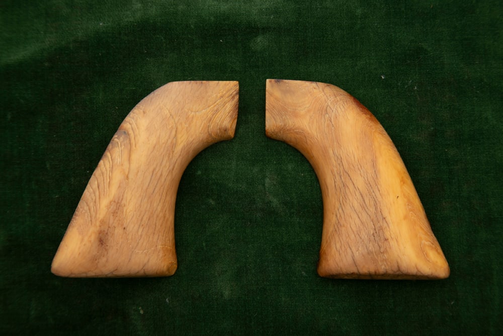 Pair of early one-piece Ivory Grips for a Colt SAA Revolver showing nice yellow aged patina.: Pair of early one-piece Ivory Grips for a Colt SAA Revolver showing nice yellow aged patina. HUTCHESON COLLECTION.