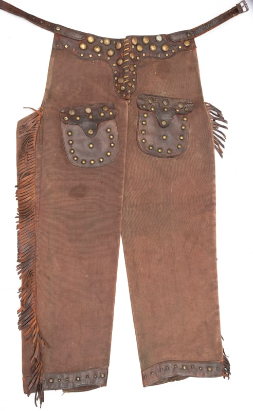 Vintage Wild West Style, fringed, leather and canvas, step in, Stovepipe Chaps with brass spotted: Vintage Wild West Style, fringed, leather and canvas, step in, Stovepipe Chaps with brass spotted belt and spotted outside pockets, circa 1920s, good condition for their age, a great decorator pair.