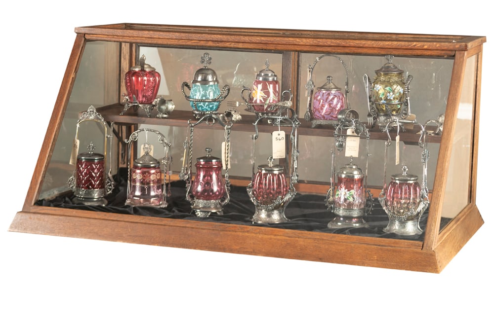 Antique oak slant front, counter top, country store Show Case, circa 1900, in original finish and: Antique oak slant front, counter top, country store Show Case, circa 1900, in original finish and condition with double sliding glass doors in rear, measures 46 1/2" W x 22 1/4" T x 27" D at base, tap