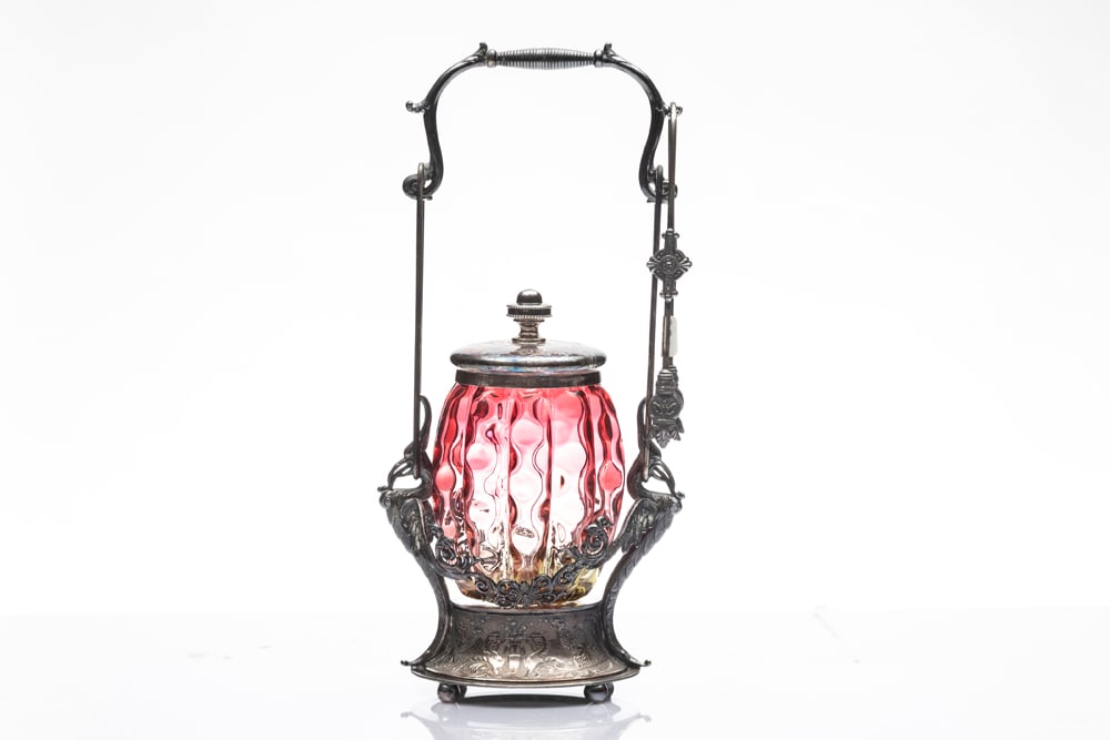 Cranberry Fluted Pickle Castor on silver footed stand with embossed birds supporting handle, 12 1/4": Cranberry Fluted Pickle Castor on silver footed stand with embossed birds supporting handle, 12 1/4" T, marked "Wilcox Silver Plate 4662". Complete with silver tongs.