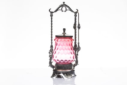 Cranberry Pickle Castor with silver tongs, footed stand with dolphins, stand is marked "James W.