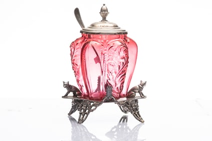 Cranberry Pickle Castor with bulbous shaped glass, silver footed stand with two dogs supporting