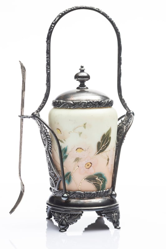 Cased glass custard color hand decorated Pickle Castor with fork in a very unusual silver stand. Has: Cased glass custard color hand decorated Pickle Castor with fork in a very unusual silver stand. Has a blue ribbon "First Award / Saginaw County Fair". Stand measures 10 1/2" T.