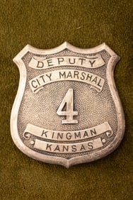 Vintage silver tone Shield Badge marked “DEPUTY/CITY MARSHAL/ 4 /KINGMAN/ KANSAS??, has lots of