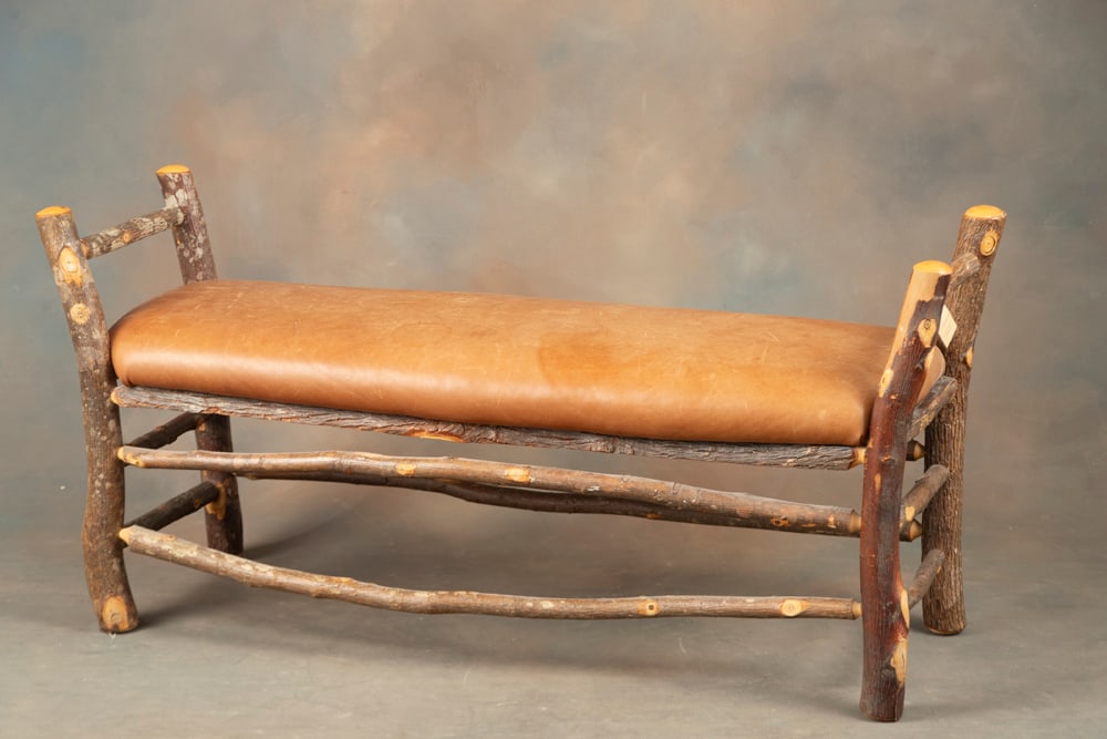 Fine Lodge Style Window Bench, very well constructed with double stretcher, covered with brown: Fine Lodge Style Window Bench, very well constructed with double stretcher, covered with brown leather cushion. Bench measures 54 1/2" L x 18" W x 25 1/2" T at top of arms.