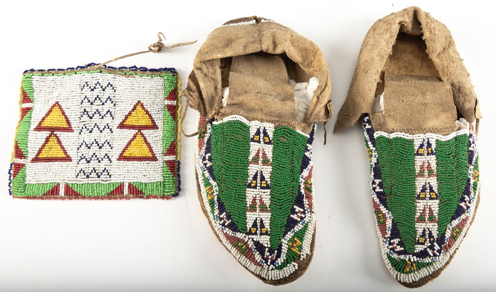 Pair of Plains Indian Beaded Moccasins, showing great age, bead work appears to be intact. Moccasins: Pair of Plains Indian Beaded Moccasins, showing great age, bead work appears to be intact. Moccasins will be accompanied by a leather and beaded Flint Bag, bag is possibly doe skin. WILL BE SOLD AS ON