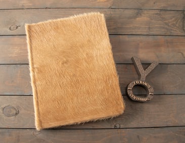 This lot consists of the following two items to include: A hair on hide Book #130 titled "A
