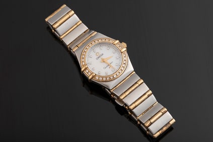 Ladies stainless and 18kt yellow gold omega constellation watch with .26ctw diamond. Showing