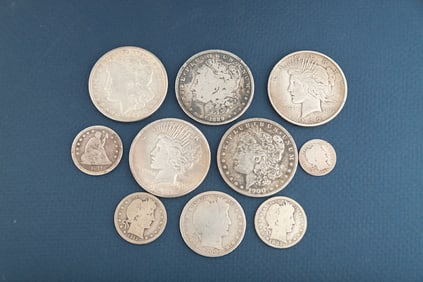 A collection of ten (10) vintage American Silver Coins to include: One O Mint Silver Dollar, dated
