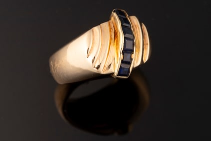 Ladies 14kt yellow gold dome ring containing six 3x3 mm princess cut sapphires. Ring weighs 12.7