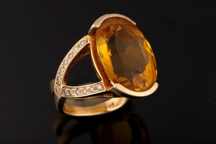 Ladies custom 14kt yellow gold ring containing on 20x15 mm oval citrine and 26 round brilliant cut
