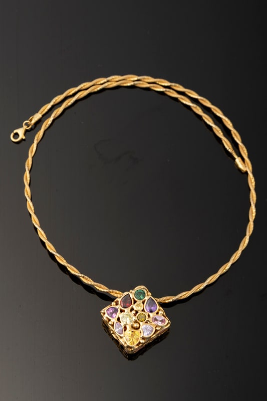 This lot consists of two Items to include: (1) Ladies 14kt woven round omega chain weighing 6 grams.: This lot consists of two Items to include: (1) Ladies 14kt woven round omega chain weighing 6 grams. Replacement Value: $800. (2) Ladies 14kt yellow gold slide pendant containing semi-precious gemston