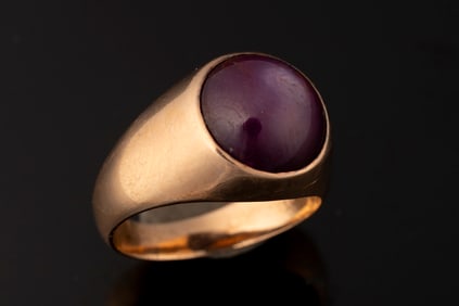 Ladies 14kt yellow gold ring weighing 10.5 grams. Ring contains one 11.88 mm Cabochon star ruby