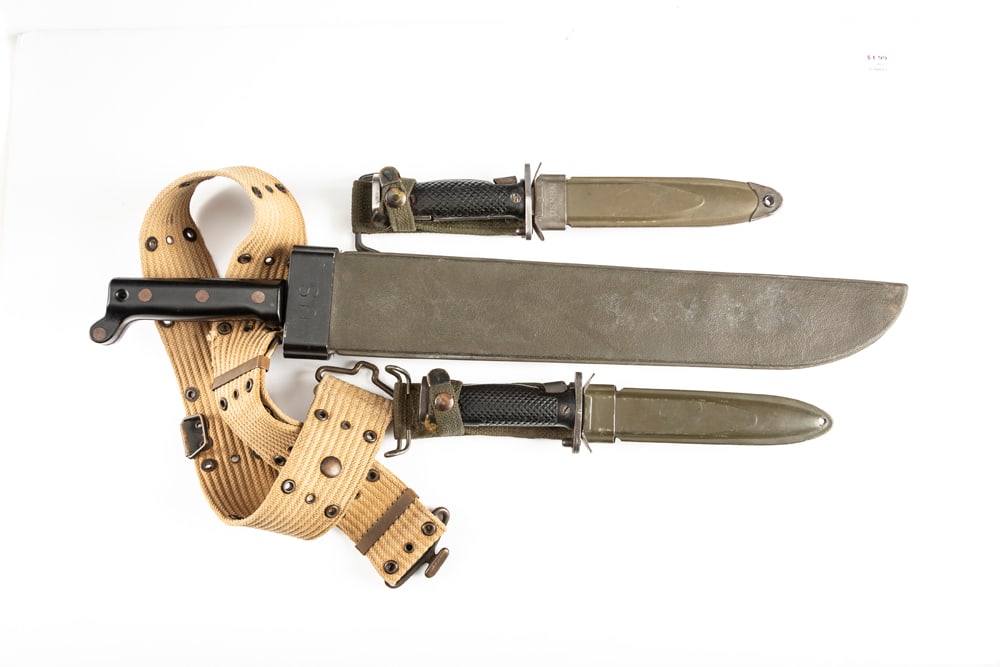 A group of Military Items to include: (1) "U.S." marked Machete, manufactured by Ontario Knife Co.,: A group of Military Items to include: (1) "U.S." marked Machete, manufactured by Ontario Knife Co., with an 18" blade, 23 1/2" overall length. Accompanied by "U.S." marked Scabbard and Military Canvas