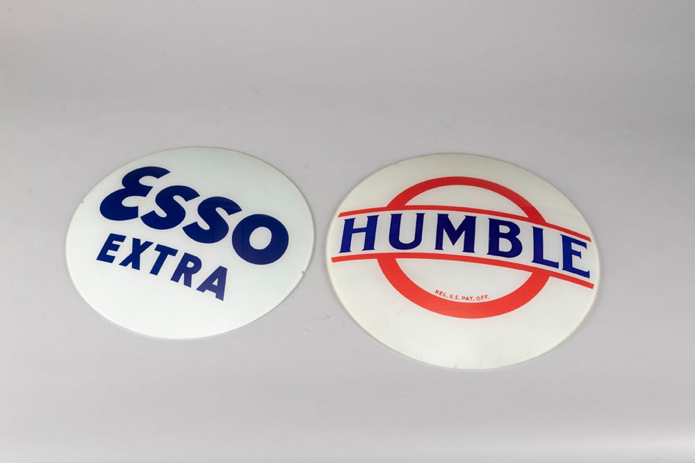 Two vintage curved glass insert Gas Pump Sign Advertisements. The Esso Extra measures 13 1/2" dia.: Two vintage curved glass insert Gas Pump Sign Advertisements. The Esso Extra measures 13 1/2" dia. The Humble measures 14 3/4". WILL BE SOLD AS ONE LOT. The Late C.W. & Marie Lyle Estate.