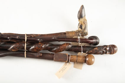 Group of four (4) vintage folk art wooden Canes. (1) A 37" L Cane with carved bust of a man pommel