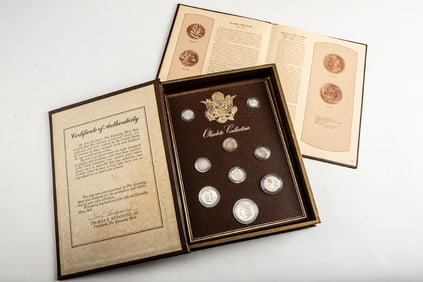 "The Kennedy Mint Portfolio of United States Coins" written by "Thomas E. Hudgeons" consisting of