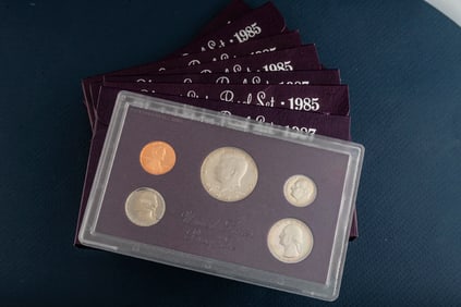 Group of seven (7) uncirculated cased U.S. Proof Sets, totaling 35 Coins. five sets are dated 1985.