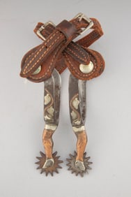 Pair of McChesney gal leg, single mounted Spurs, #6, with raised vines and leaves on heel bands,