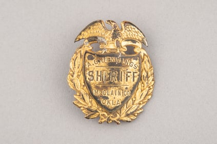 Gold tone vintage Shield Badge with eagle crest marked "A.G. Jennings/Sheriff/McClain Co. Okla."