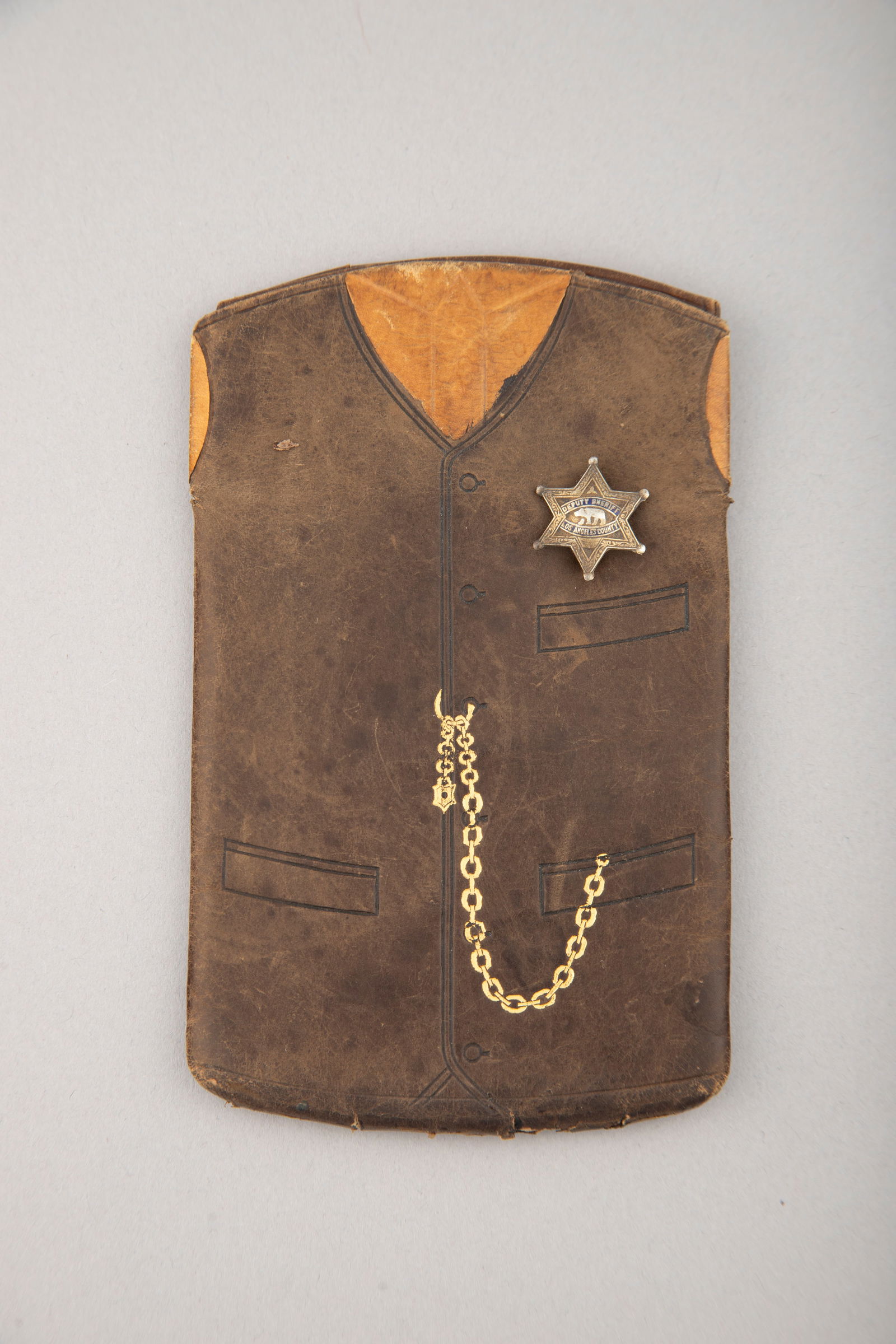 Unique vintage leather, two tone Pocket Protector with three dividers, shaped like a leather vest: Unique vintage leather, two tone Pocket Protector with three dividers, shaped like a leather vest with sterling marked 6-point star badge marked "Deputy Sheriff, Los Angeles County" with embossed bear
